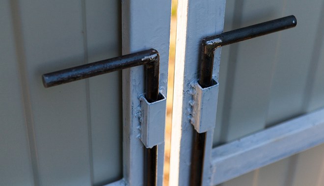 Фиксаторы ворот, сделанные из сваренной буквой "Г" гладкой арматуры